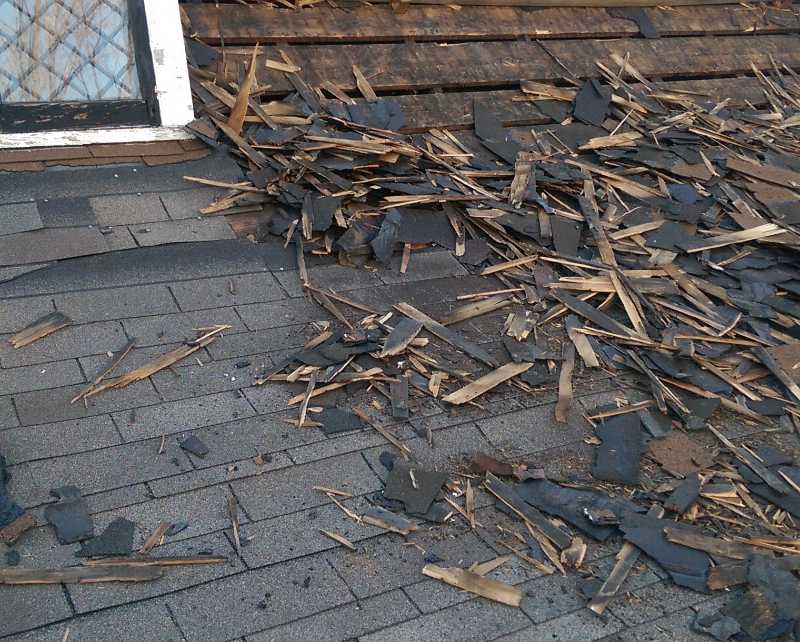 a roof with broken shingles all over