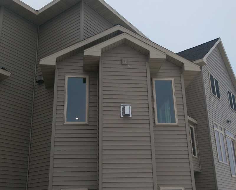 a house with new gray siding and windows